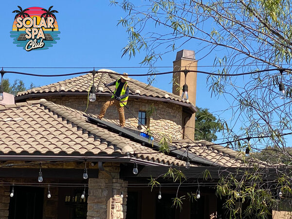 Solar Spa Club technician cleaning a home's solar panels
