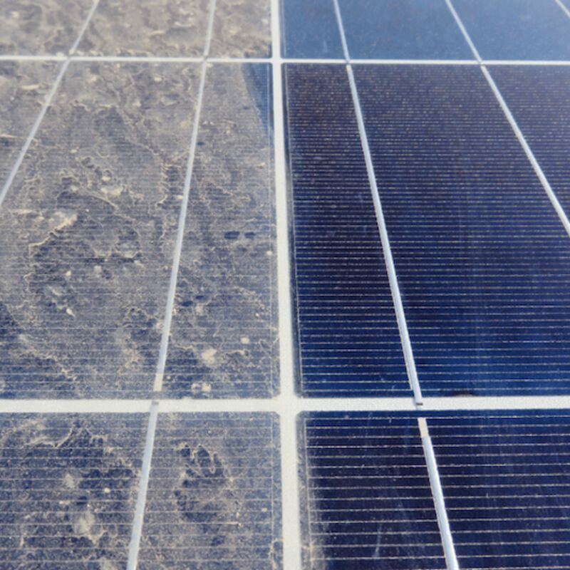 Solar panels covered in dust and debris before cleaning
