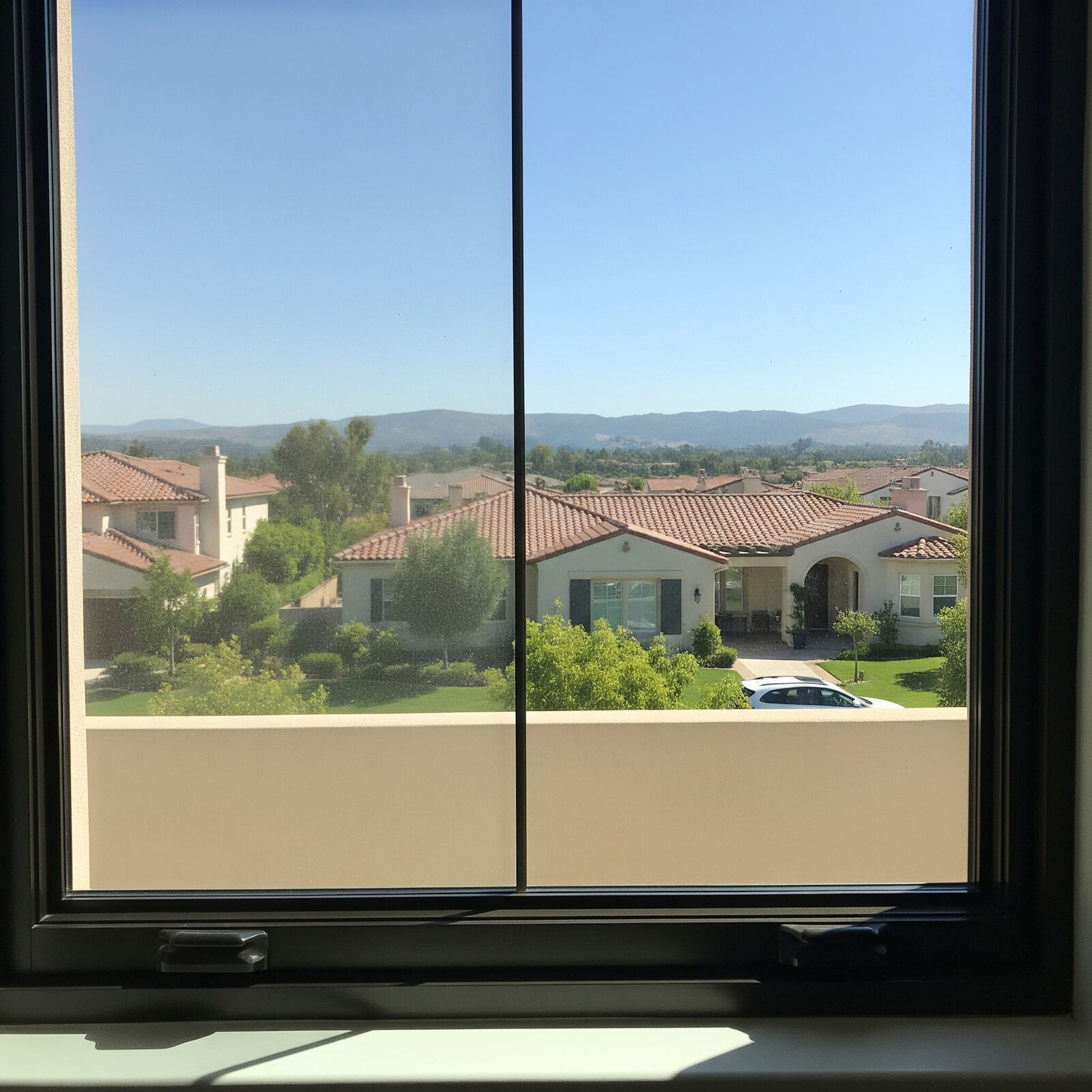 Window with hard water spots and film before cleaning
